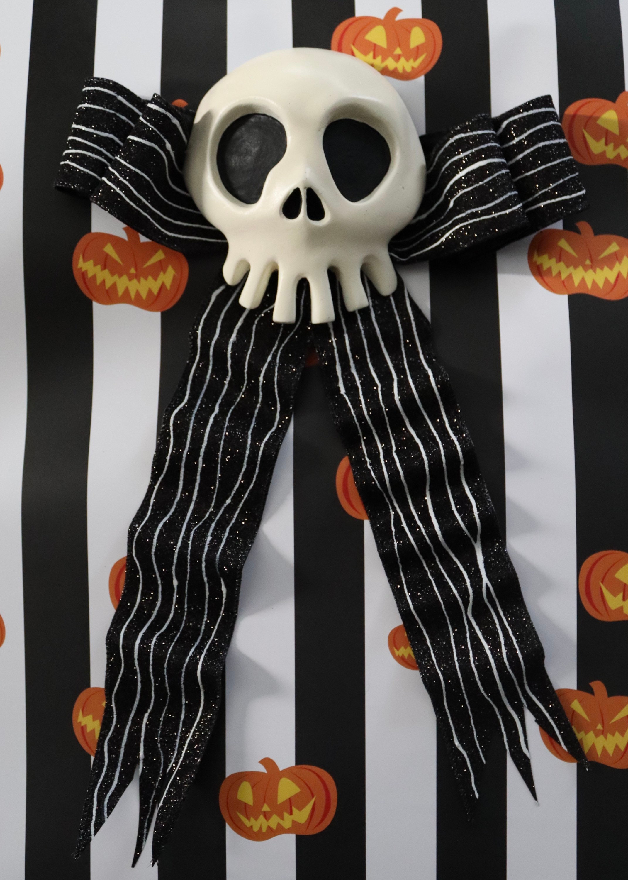 Haunted Mansion Holiday Skull And Skellington Pinstripe Bow Hanging Haunted Mansion Holiday Skull And Skellington Pinstripe Bow Hanging