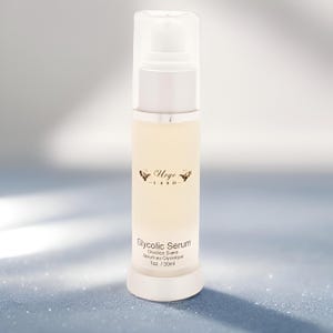 May include: A white and silver bottle of Glycolic Serum with a clear pump top. The bottle has the brand name "Urge Lash" and the product name printed in English and Spanish. The bottle contains 1 fl oz / 30ml of serum.
