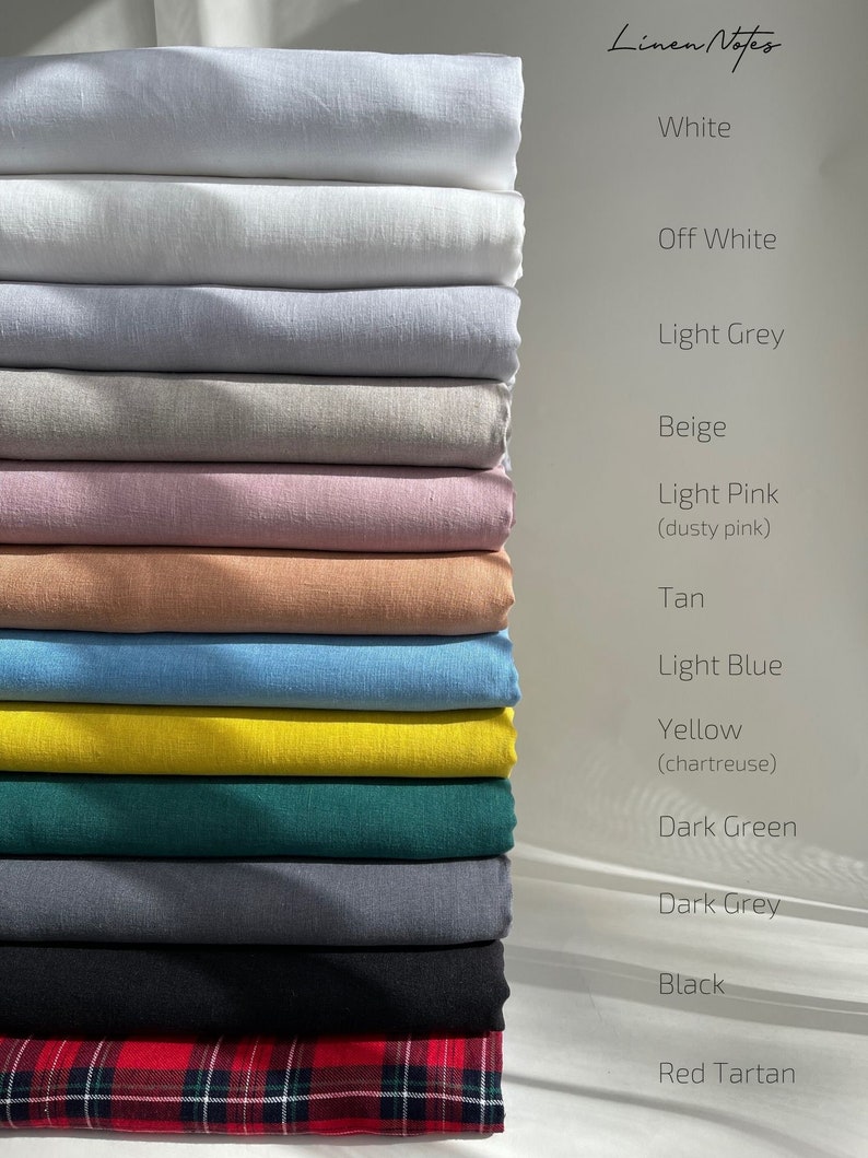 May include: A stack of 14 fabric swatches in various colors, including white, off-white, light grey, beige, light pink, tan, light blue, yellow, dark green, dark grey, black, and red tartan.