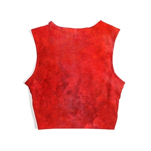 May include: A sleeveless, cropped top in a vibrant red hue. The fabric has a textured appearance, with darker red and maroon accents throughout. The top features a high neckline and a cropped length, suitable for warm weather.