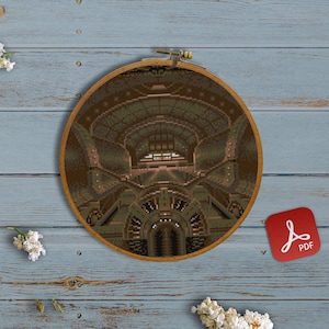 May include: A cross-stitch pattern of a detailed interior space with a vaulted ceiling, framed in a wooden embroidery hoop. The hoop is on a blue wooden surface with white flowers and colorful embroidery floss.