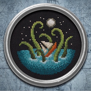 May include: A circular cross-stitch embroidery featuring a black background with a blue ocean, a small orange boat, and green tentacles emerging from the water under a white moon and stars. The text PDF Pattern Instant Download is visible.