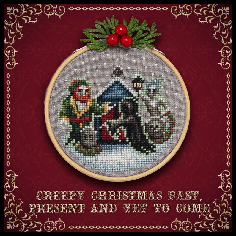 May include: A cross-stitch embroidery hoop with a winter scene featuring three figures, a house, and a snowy landscape. The text "Creepy Christmas Past, Present and Yet to Come" is written below the hoop.