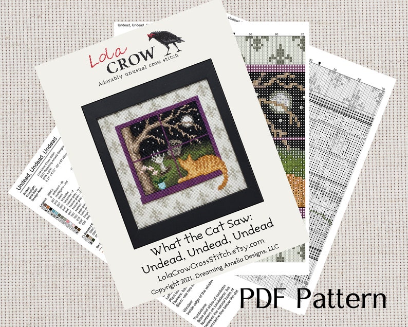 May include: A cross stitch pattern titled "What the Cat Saw: Undead, Undead, Undead" by Lola Crow Cross Stitch. The pattern features a cat looking out a window at a spooky scene with a full moon, a tree, and a tombstone.