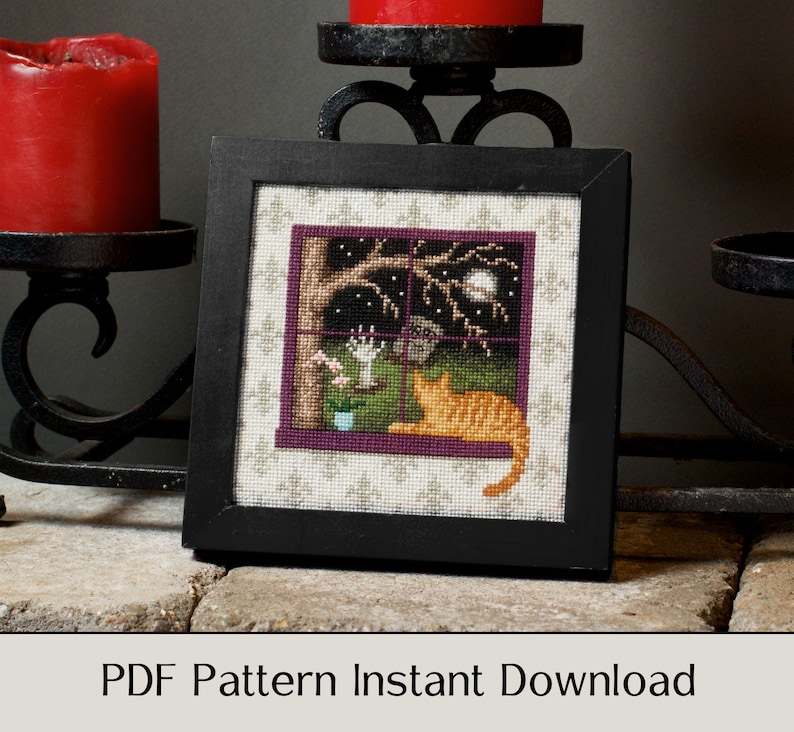 May include: A cross-stitch pattern featuring a cat looking out a window at a spooky night scene. The window is framed in purple and the scene includes a tree, a moon, and a hand reaching out from behind the tree. The pattern is framed in black and is ready for instant download.