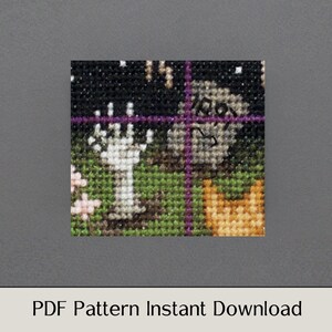 May include: A cross-stitch pattern featuring a spooky Halloween scene with a ghost, a graveyard, and a pumpkin. The pattern is in black, white, green, orange, and purple.