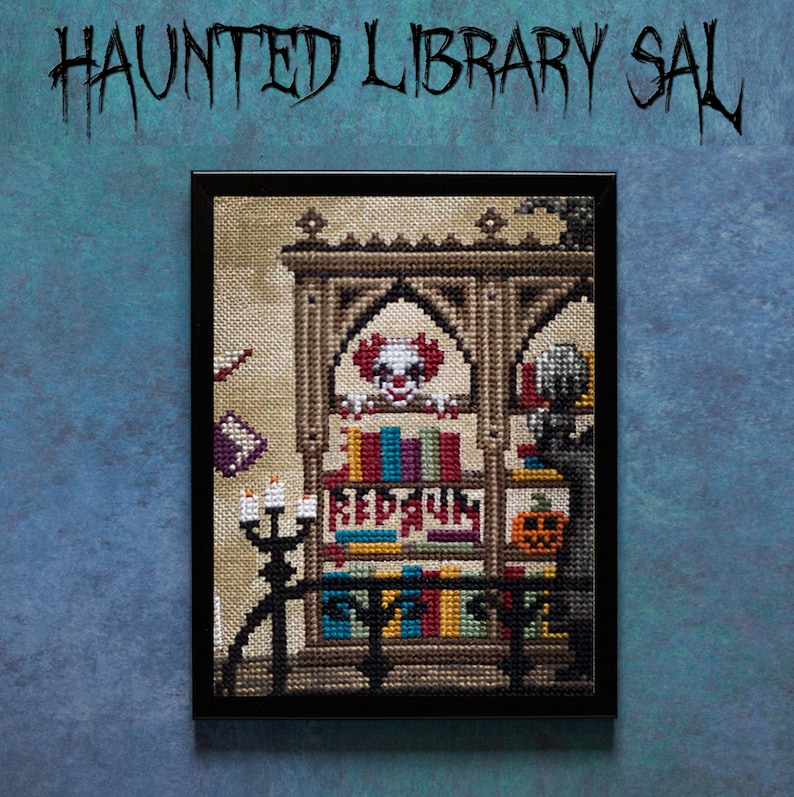 May include: A framed cross-stitch artwork depicting a haunted library with a bookshelf filled with books, a spooky clown peeking from behind the books, and a pumpkin. The text "REDRUM" is visible on the bookshelf.