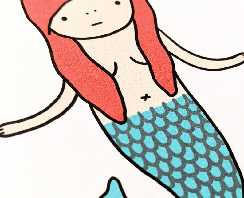 May include: A cartoon illustration of a mermaid with red hair and a blue and gray fishtail.