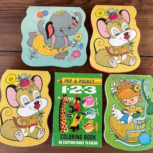 May include: A selection of vintage children's books and a colouring book. The books feature colourful illustrations of an elephant, mice, and a girl knitting. One book is titled "POP-A-POCKET 1-2-3 COLORING BOOK" with 96 pages.