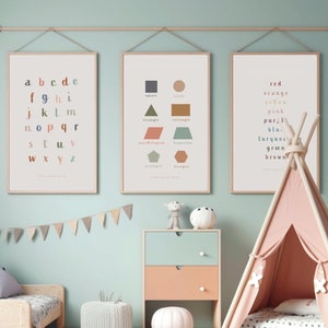 May include: Three framed educational posters for children, hanging on a wall. The posters feature the alphabet, basic shapes, and colours. A pink teepee tent is in the foreground.
