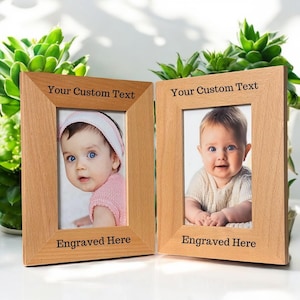 May include: Two wooden picture frames with a light brown finish. Each frame has a space for a 4x6 inch photo and a space for personalized text. The text on the frames reads "Your Custom Text" and "Engraved Here".