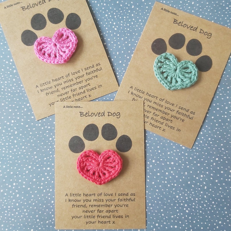 May include: Three brown cards with the text "Beloved Dog" and a crocheted heart in pink, green, and pink. Each card has the text "A little heart of love I send as I know you miss your faithful friend, remember you're never far apart your little friend lives in your heart x"