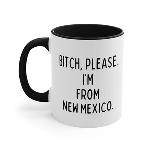 May include: White ceramic mug with a black handle and interior. The mug features the text "Bitch, Please. I'm From New Mexico" in black, bold font.