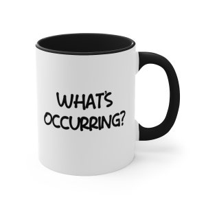 May include: White ceramic mug with a black interior and handle. The mug features the phrase "WHAT'S OCCURRING?" in black, bold, handwritten-style lettering. The mug is designed for hot or cold beverages.