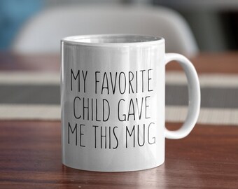 May include: White ceramic mug with black text that reads "My favorite child gave me this mug".