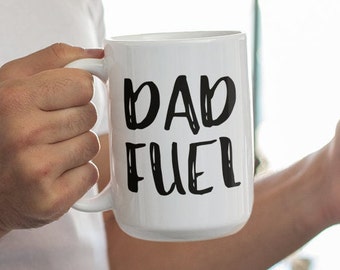 May include: White ceramic coffee mug with black text that reads "DAD FUEL".