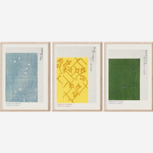 Puede incluir: Tres impresiones enmarcadas con texto japonés y patrones abstractos. La primera impresión presenta un patrón azul y blanco, la segunda impresión presenta un patrón amarillo y dorado, y la tercera impresión presenta un patrón verde y blanco.