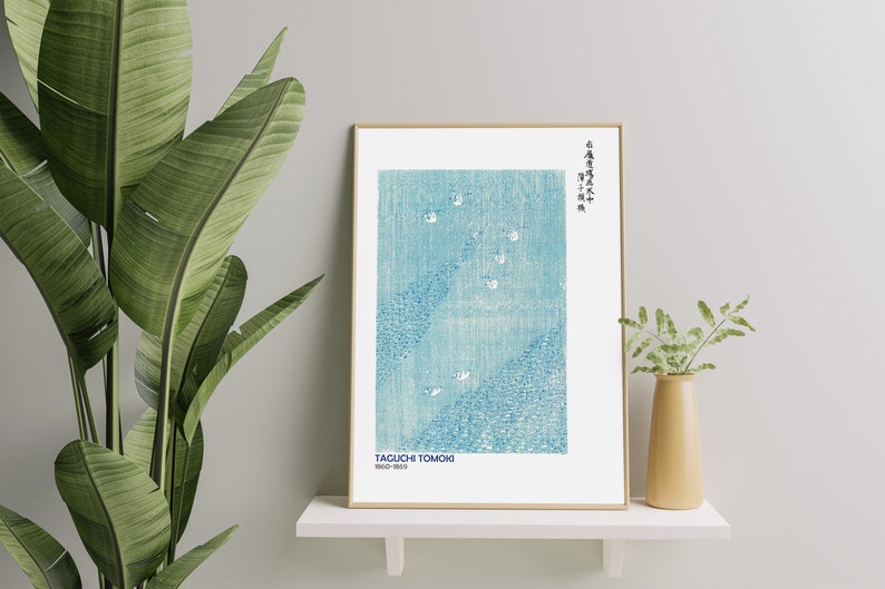 May include: A framed print of a blue and white Japanese woodblock print with the text "TAGUCHI TOMOKO 1903-1980" and Japanese characters at the top right corner.