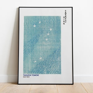 May include: A framed print of a blue and white Japanese woodblock print by Taguchi Tomoki (1860-1869). The print depicts a scene of birds flying over a body of water. The Japanese text in the upper right corner reads "Taguchi Tomoki"
