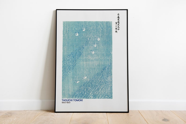 May include: A framed print of a blue and white Japanese woodblock print by Taguchi Tomoki (1860-1869). The print depicts a scene of birds flying over a body of water. The Japanese text in the upper right corner reads "Taguchi Tomoki"