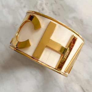 Chanel vintage large CHANEL logo white and gold XL bracelet, collector’s piece from spring summer 1990 RTW runway