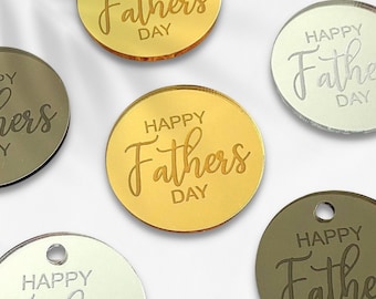 May include: Six round, mirrored acrylic tags with the text "Happy Fathers Day" in a cursive font. The tags are in gold, silver, and bronze.