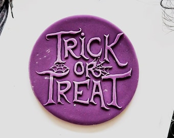 May include: Purple round silicone stamp with the words "Trick or Treat" in a decorative font.
