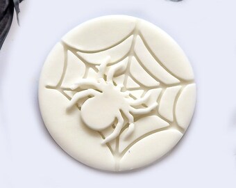 May include: White fondant cookie cutter with a spider and web design.