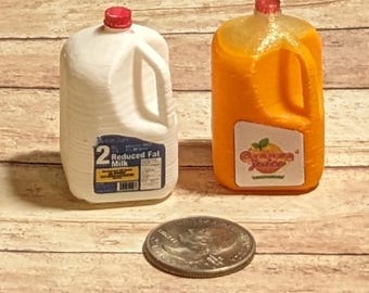 May include: Two miniature plastic gallon jugs, one white with a red lid and the label "2% Reduced Fat Milk", and the other orange with a red lid and the label "Orange Juice".