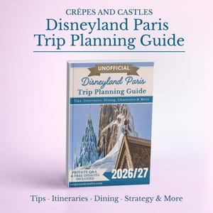 May include: A guidebook titled Crêpes and Castles Disneyland Paris Trip Planning Guide 2026/27. The cover features a blue and white illustration of a castle and mountain, with text including Tips, Itineraries, Dining, Characters & More.