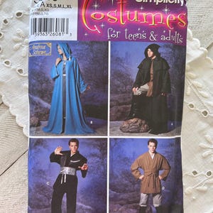 May include: A Simplicity sewing pattern envelope labeled 5540 for costumes for teens and adults. The front displays four variations of hooded cloaks, robes, and tunics with belts, featuring models in blue, black, and brown garments against a dark background.