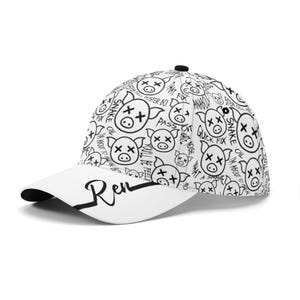 May include: White baseball cap with a black brim and a black top button. The cap features a repeating pattern of cartoon pig faces with cross-out eyes and various phrases. The word "Ren" is written on the front.