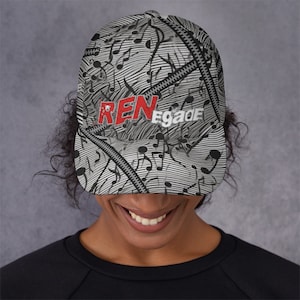 May include: A baseball cap with a black and white musical note pattern and a zipper design. The word "RENegade" is printed on the front in red and white. The cap is worn by a person.