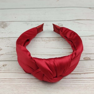 Pamper your loved one with a comfortable and stylish padded red satin headband.