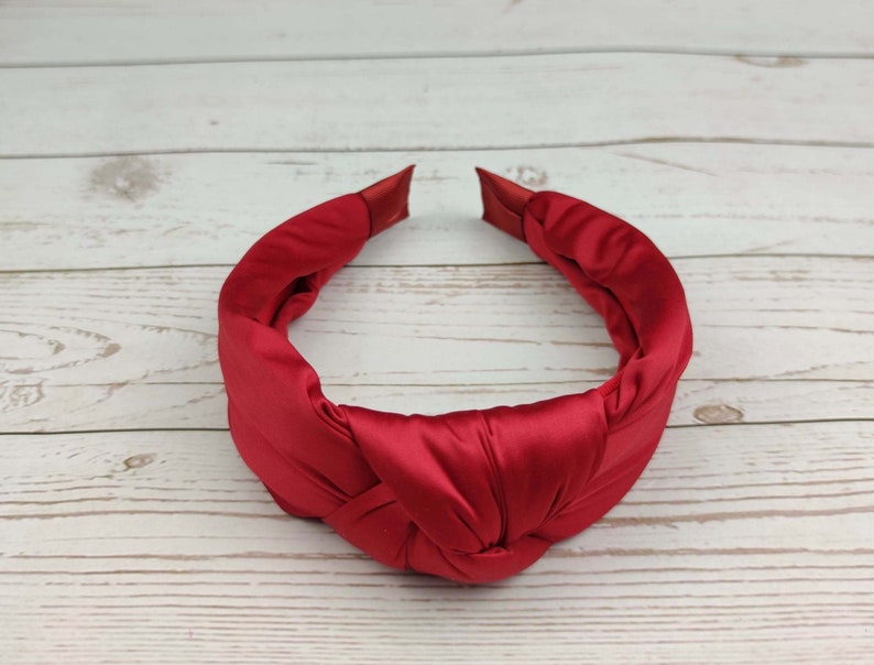 Pamper your loved one with a comfortable and stylish padded red satin headband.