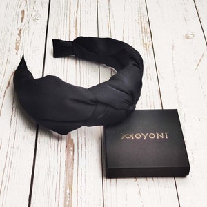 Keep your hair looking neat and tidy with this stylish Black Headband. It comes in various sizes to fit any head, is made from quality materials, and is sure to make a statement.