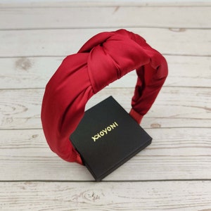 Add a pop of color to your sweetheart hairstyle with this gorgeous red satin headband.