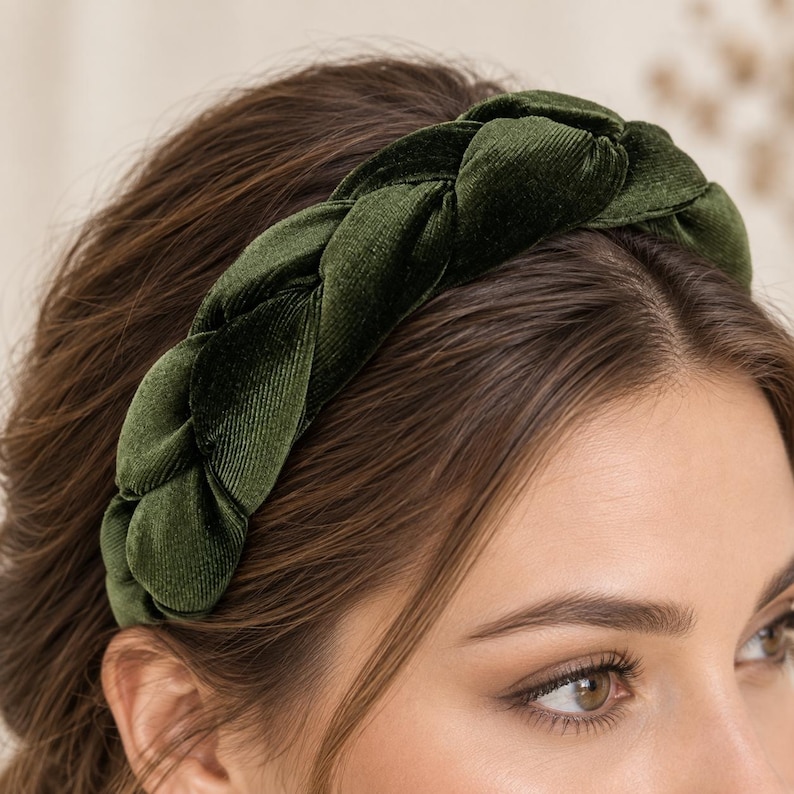 Close-up detail of a dark olive green velvet braided headband showing the soft ribbed texture, padded plait and fabric finish.