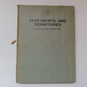 May include: A green book with the title "Apartments and Dormitories: An Architectural Record Book" printed on the front cover.