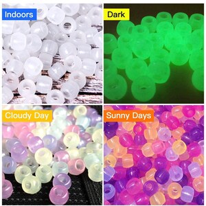 May include: Four groups of glow-in-the-dark beads in different colors. The first group is white, the second is green, the third is a mix of pastel colors, and the fourth is a mix of purple, pink, and yellow.