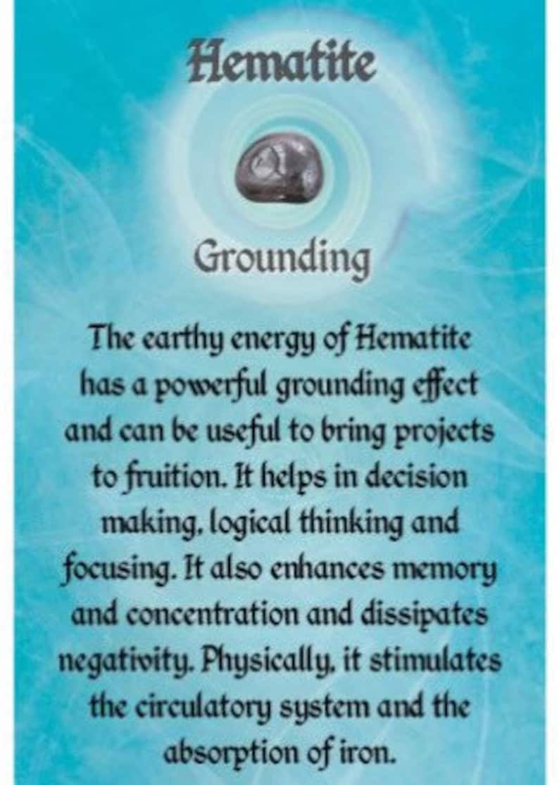 May include: A close-up of a gray hematite crystal with the text "Hematite" and "Grounding" on a blue background. The text describes the grounding properties of hematite, its ability to enhance memory and concentration, and its positive effects on the circulatory system.
