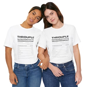 May include: Two people wearing white t-shirts with a graphic of a nutrition facts label that says "Throuple Nutrition Facts". The label lists different categories like communication, love, trust, passion, compromise, balance, and romance with percentages next to each category.