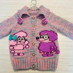Girl size 2-3 yrs, hand knit, woollen cardigan featuring Coco and Coco’s mum from Bluey cartoon series.