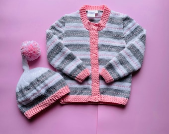 Girl’s size 2, handknitted, woollen, cardigan and hat; striped, pink, grey, white, merino wool and acrylic mix.