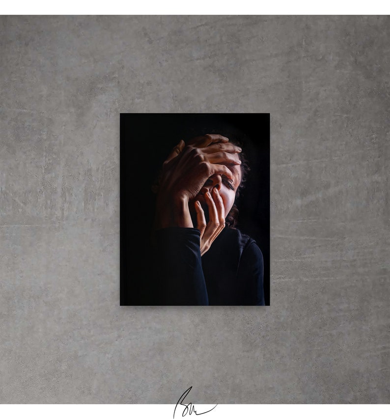 May include: A black and white photograph of a person with their hands covering their face. The person is wearing a black shirt and has dark hair.