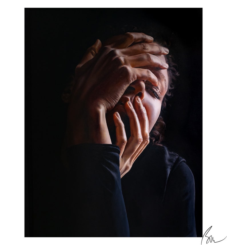 May include: A person with dark hair covers their face with their hands. The person is wearing a dark shirt and is lit from the side, creating a dramatic effect.