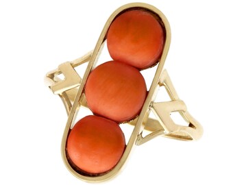 May include: A gold ring with three round coral stones set in a geometric design.