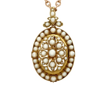 May include: A gold and pearl pendant necklace with an oval-shaped design. The pendant features a central flower motif surrounded by a circle of pearls.