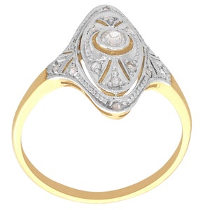 May include: A gold ring with a diamond set in a delicate, oval-shaped design. The ring is adorned with intricate details and a sparkling center stone.