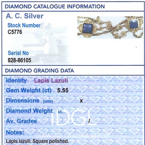 May include: A close-up of a jewelry piece featuring two square lapis lazuli stones set in gold. The stones are surrounded by a delicate gold chain. The image includes the text "Diamond Catalogue Information", "A. C. Silver", "Stock Number C5776", "Serial No 828-86105", "Diamond Grading Data", "Identity Lapis Lazuli", "Gem Weight (ct) 5.55", "Dimensions (mm)", "Diamond Weight ct.", "Av. Grades", "Notes:", "Lapis lazuli: Square polished."
